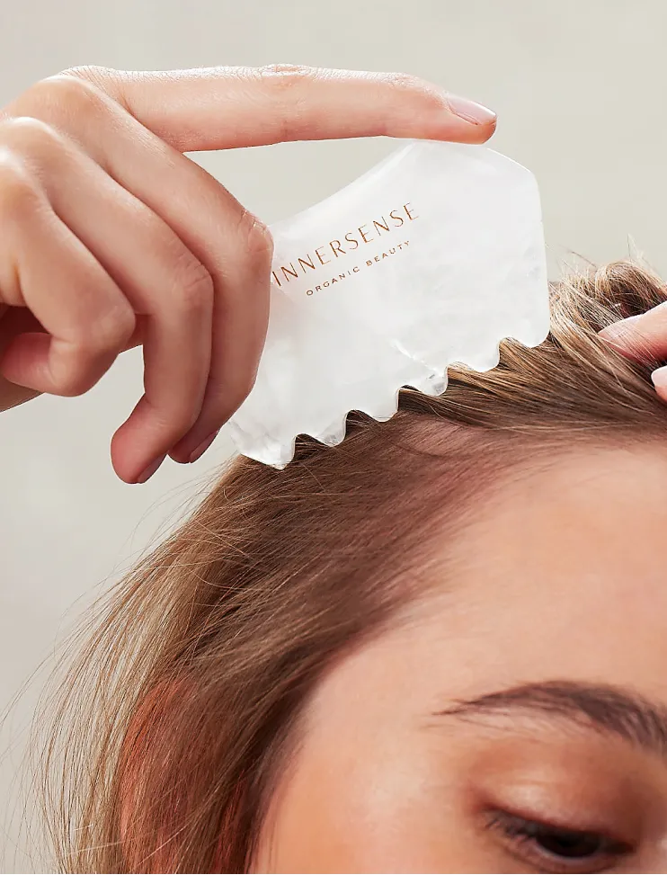 A person using the Innersense scalp massager for healthy scalp