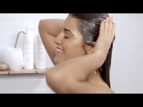 Video of how to shampoo and condition color treated hair with Innersense's Awakening + Radiance products - clean beauty hair tips - cover photo is of a woman applying organic shampoo to her hair in the shower