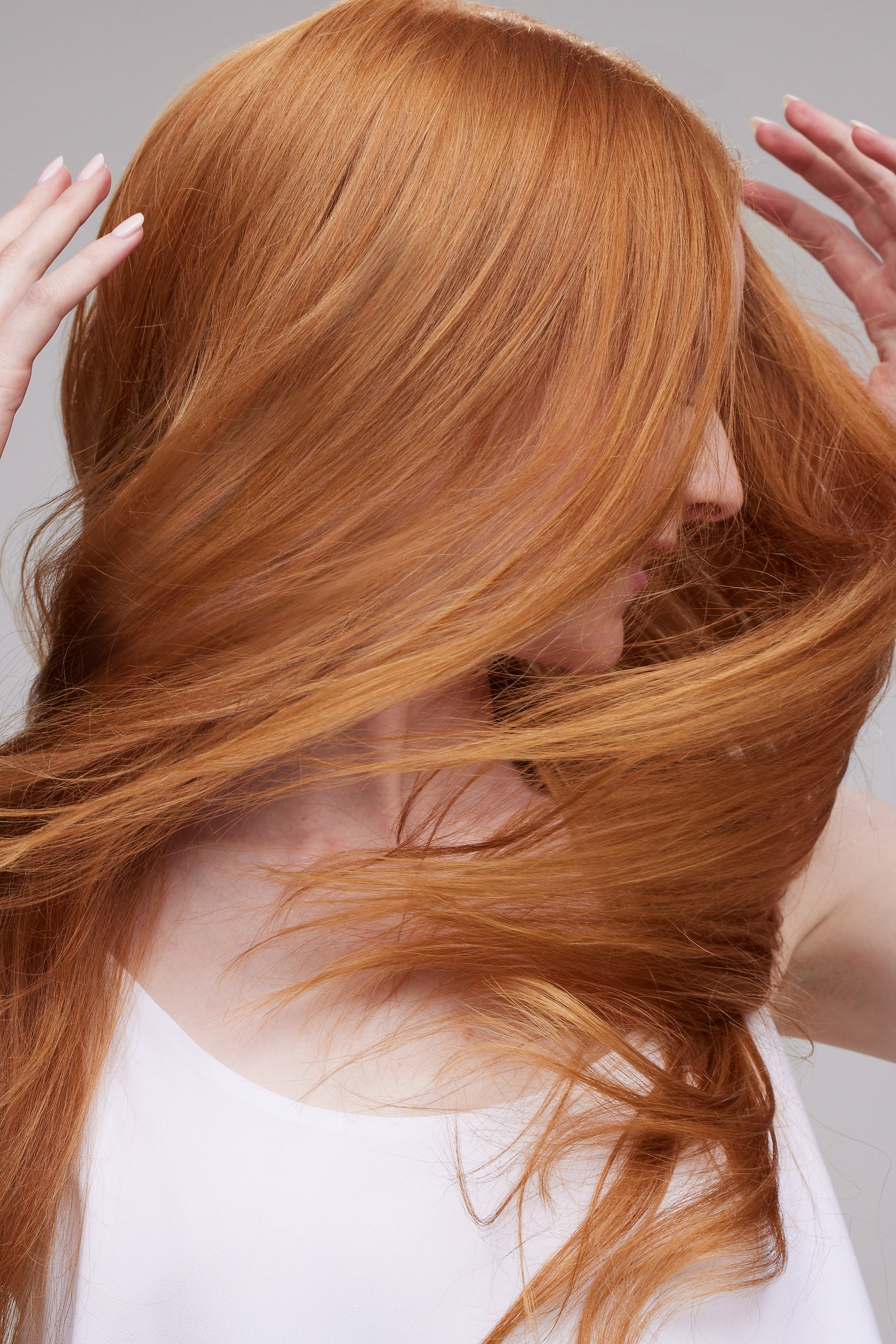 a person using haircare products for brightly coloured hair, red hair