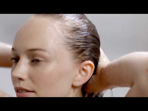 Learn how to cleanse and condition with Innersense's organic haircare - cover photo is a woman cleansing her hair in the shower